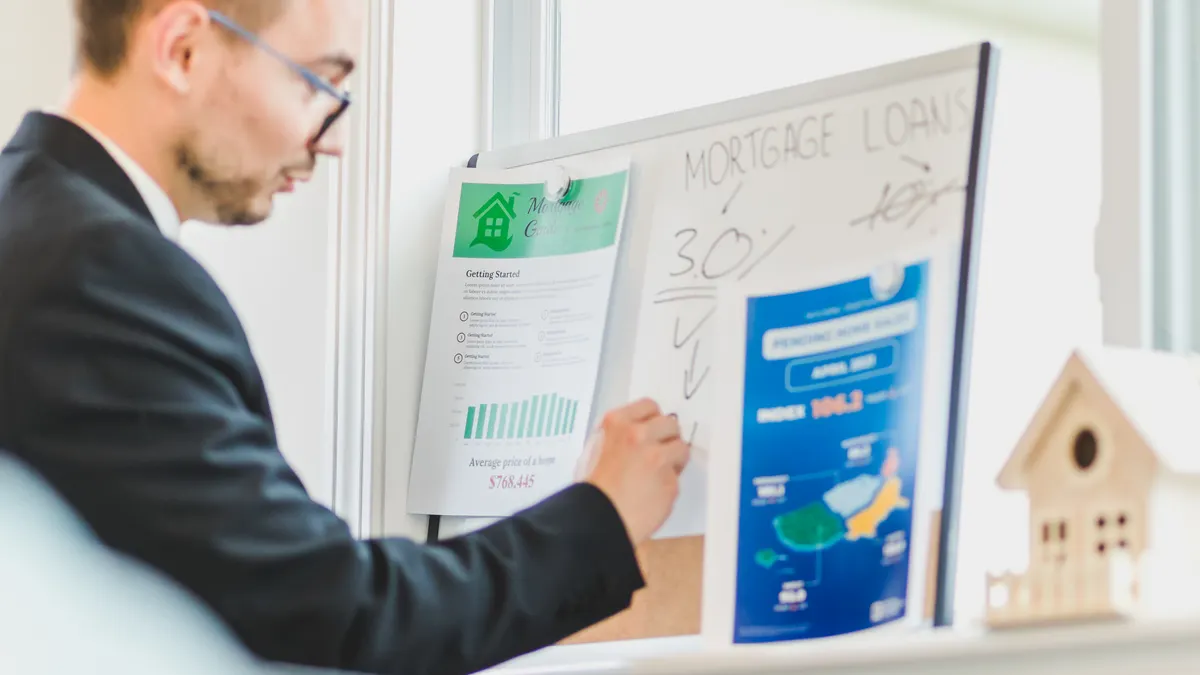 Man pointing at a mortgage loan board